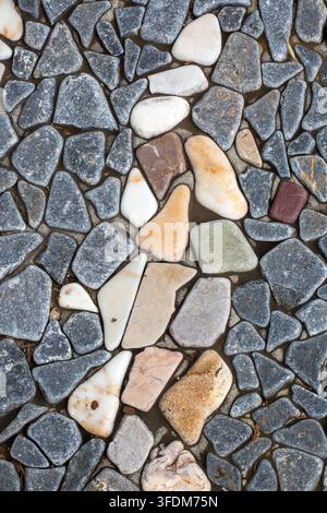 Seamless texture of flat smooth river stones and pebbles mosaic pavement background Stock Photo