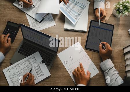 Business team meeting to brainstorm a new business project, analyzing financial reports, charts and budget data for consulting, finance planning, team Stock Photo