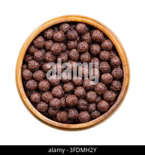 Choco balls, crispy breakfast cereal in wooden bowl, isolated from above. Crispy corn food made of toasted cornmeal, cocoa powder, and sweetened. Stock Photo