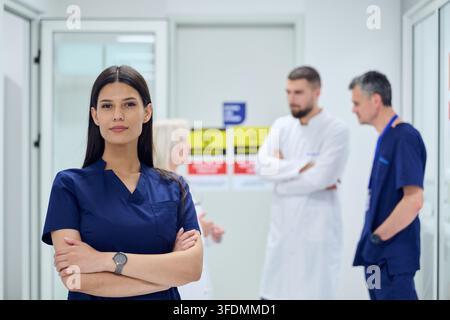 Healthcare professionals collaborating in a hospital setting with focus on a confident female doctor Stock Photo