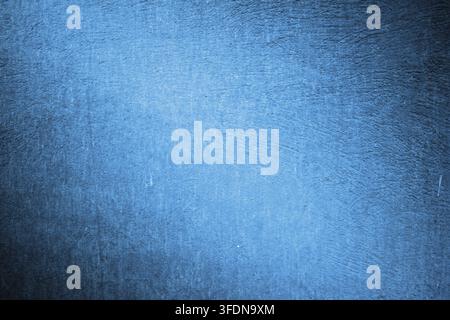 Bright blue abstract wall texture with plaster and light accent in the center. Stock Photo