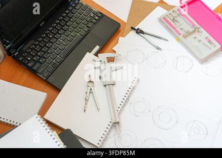 Engineer Workspace Laptop, Technical Drawings, Vernier Caliper, Compasses Stationery Tool Top view architect desk Geometric sketches dividers engineering and drafting. Study background Stock Photo