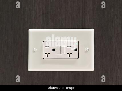 white 20-amp GFCI Ground Fault Circuit Interrupter electrical outlet with T-slot sockets. Stock Photo