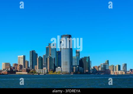 Panoramic view of the modern Jersey City skyline in New Jersey as seen across the open water of New York Bay Stock Photo
