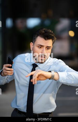 Stressed businessman checking watch realizing time running out Stock Photo