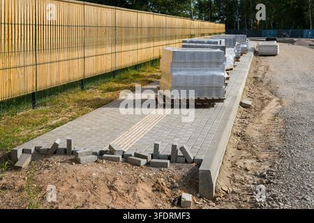 Concrete Paving Stone Walkway Installation at Active Construction Site Stock Photo