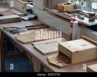 Handmade Wooden Bat Boxes on a Workshop Bench Stock Photo