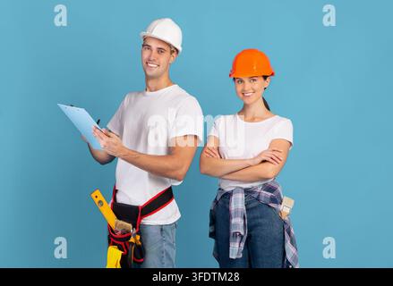 Repairment Budget Planning. Portrait Of Man And Woman Repair Masters In Helmets Stock Photo