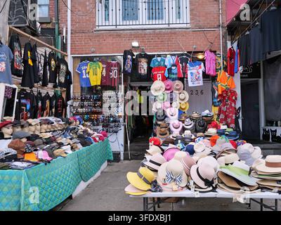 Store selling hats on outdoor tables, Kensington Market bazaar, Toronto Stock Photo