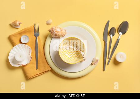 Summer dining and coastal lifestyle, table setting with seashells and yellow chevron bowl for beach house vacation or tropical restaurant Stock Photo