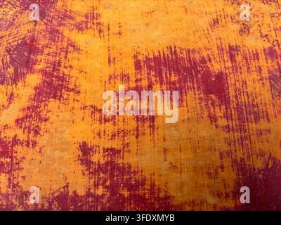 Old red and orange painted metal sheet for use as a background texture Stock Photo