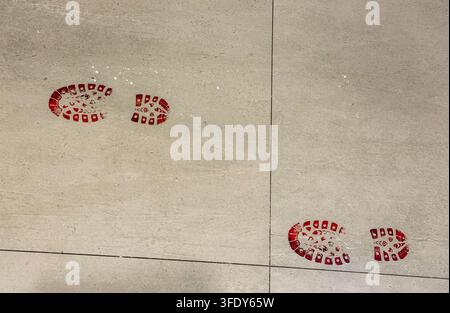 red bloody footprints on grey floor, halloween banner concept of halloween, crime, party Stock Photo