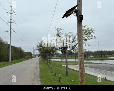 A solar-powered license plate reading camera manufactured and operated by Flock Safety is mounted on a wooden utility pole near Echo Lake in Fort Worth, Texas. The automated license plate reader (ALPR) device, affixed alongside a solar panel, is part of a surveillance network used by law enforcement agencies to track vehicle movements and aid in criminal investigations. (Photo by Cody Copeland/Fort Worth Star-Telegram/TNS/Sipa USA) Stock Photo