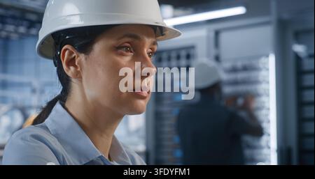 Close Up of Female Specialist Operates Desktop Station Displaying 3D Automotive Models inside Modern Smart Factory. Integrated Digital Twin Technology and Server Systems Streamline Plant Workflow. Stock Photo