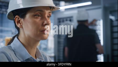 Close Up of Female Specialist Operates Desktop Station Displaying 3D Automotive Models inside Modern Smart Factory. Integrated Digital Twin Technology and Server Systems Streamline Plant Workflow. Stock Photo