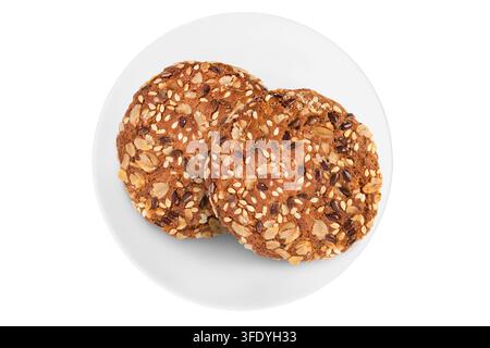 Oatmeal grain cookies on white ceramic dish isolated on white background Stock Photo