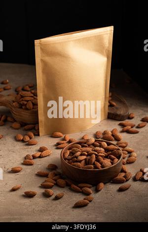 Kraft paper pouch mockup with almonds on stone Stock Photo