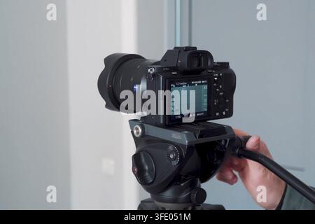A camera mounted on a tripod Stock Photo