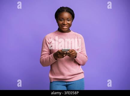 Mobile Offer. Positive Black Millennial Female Posing With Smartphone In Hands Stock Photo