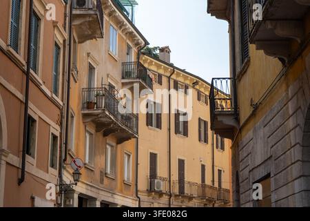 Charming narrow Street with Historic house Buildings and Balconies in Old Town Verona, Italy. Stock Photo