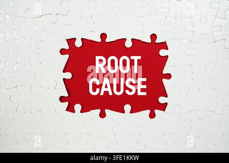 Jigsaw puzzle with a missing piece with "Root Cause" on red background Stock Photo