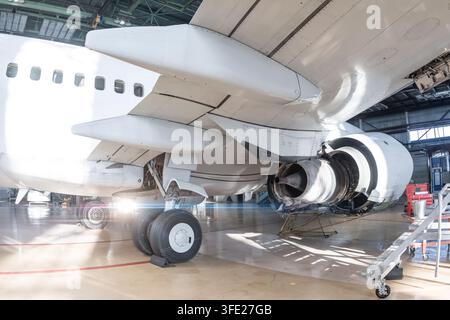 Commercial Aircraft Engine Undergoing Maintenance in an Aviation Hangar. Airplane under maintenance. Checking mechanical systems for flight operations Stock Photo