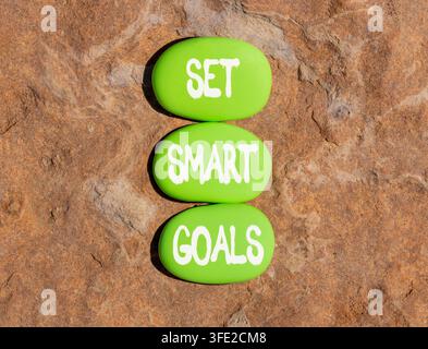 Set smart goals words symbol. Concept words Set smart goals on beautiful green stones. Beautiful stone beach background. Business and set smart goals Stock Photo