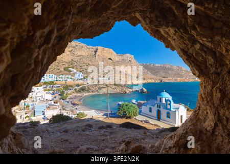 View of sea bay with beautiful beach and traditional church on Karpathos island in Foiniki village, Greece Stock Photo