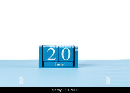 Wooden calendar June 20 on a white background close up Stock Photo