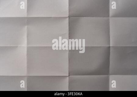 Folded paper texture background with grid creases and geometric shadow pattern. Minimalist geometric pattern with creases, grid squares, and soft shad Stock Photo