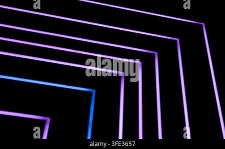 Glowing neon stripped lights on dark background Stock Photo