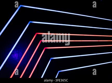 Glowing neon stripped lights on dark background Stock Photo