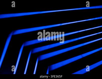Glowing neon stripped lights on dark background Stock Photo