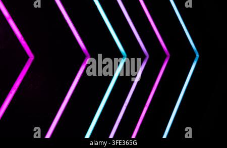 Glowing neon stripped lights on dark background Stock Photo