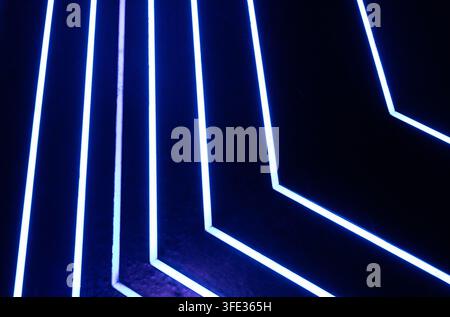 Glowing neon stripped lights on dark background Stock Photo