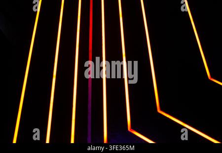 Glowing neon stripped lights on dark background Stock Photo
