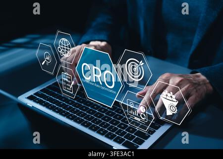 CRO, conversion rate optimization technology concept. Businessman using laptop with CRO related technology icons, symbolizing conversion rate optimiza Stock Photo