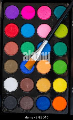 Colorful watercolor paint set with paintbrush Stock Photo