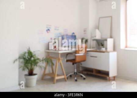 Blurred view of data scientists office with workplace, diagrams and plants Stock Photo