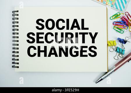 Social Security Changes text message written on notepad with stationery flat lay on white background Stock Photo