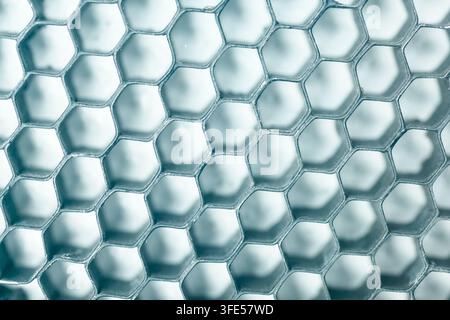 Abstract background texture featuring a metallic blue honeycomb grid structure with geometric hexagonal cells Stock Photo