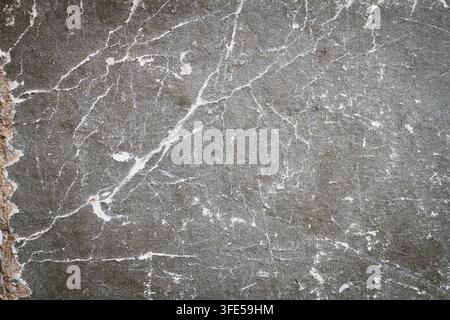 Grey grainy texture with cracks and scratches. Old frayed texture. Gray background. Stock Photo