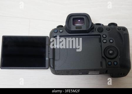 Close-up of the back of a Canon R6 Mark II camera showing the articulated LCD screen and control buttons. Stock Photo
