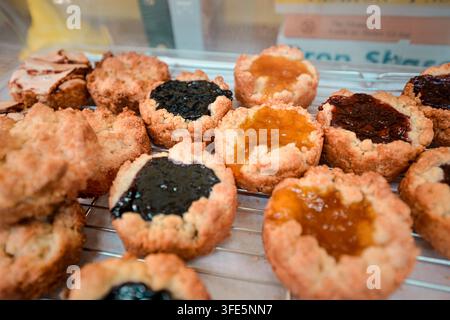 Close-up of assorted Korean jam tarts and pastries cooling on a wire rack in Korea bakery. Stock Photo