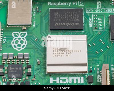 Extreme macro of Raspberry Pi 5 Broadcom CPU chip on green circuit board Stock Photo