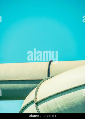 Minimal turquoise and white poolside detail with curved architectural forms and a dark cable. Stock Photo