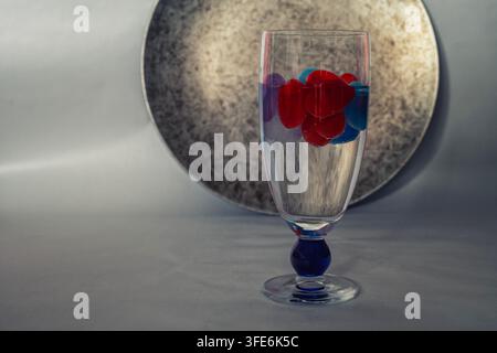 Glass with a drink and floating hearts, drinks decoration Stock Photo