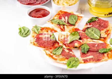 Flatbread Pepperoni Pizza. Viral pizza on tortilla pita bread, with tomato marinara sauce, grated cheese and pepperoni Stock Photo