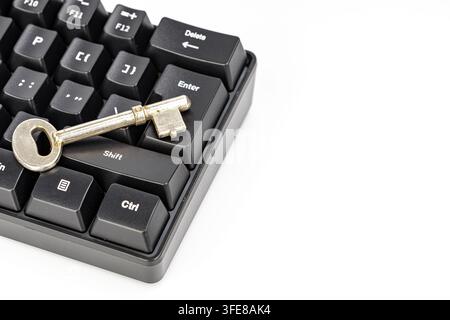 Vintage key on a keyboard enter button, symbolizing cybersecurity, access, and the risks of digital actions. Stock Photo