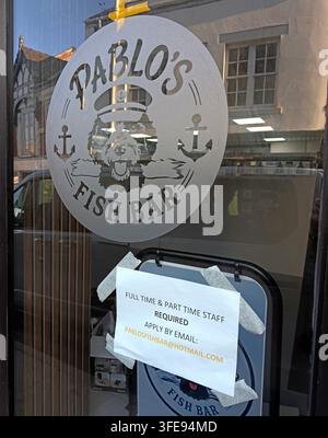 Fish and chip shop recruitment sign in Northwich, Cheshire, highlighting local vacancies amid concern over youth unemployment and NEET rates Stock Photo